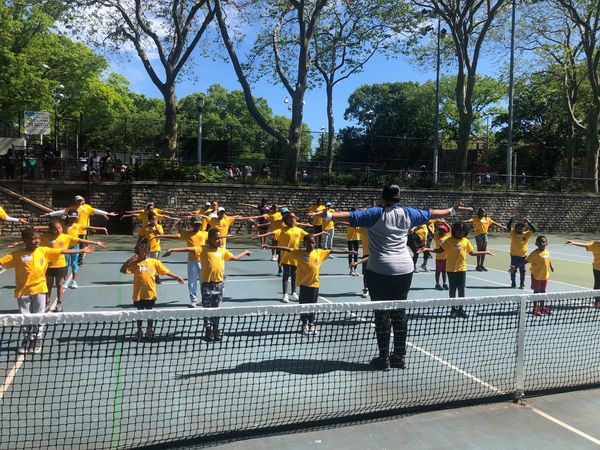Kids Doing Warm-up Exercises With Instructor
